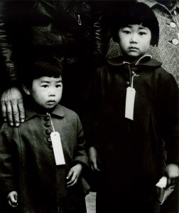 Japanese-Americans were tagged en route to internment camps in 1942. Photo: Dorothea Lange © 1942.