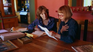 Jane Anderson (right) and her spouse, producer Tess Ayers, search for clues to great-aunt Edith Wilkinson's backstory in PACKED IN A TRUNK. Photo courtesy HBO.