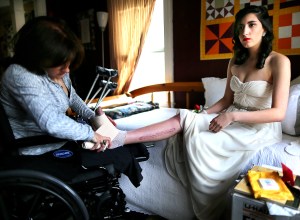 18-year-old Sydney Corcoran, a victim of the Boston Marathon bombing, preps for her Lowell (Mass.) Senior Prom. Her mom, Celeste, who lost both her legs in the bombing, changes the bandages on her daughter's injured foot. Photo: John Tlumacki/The Boston Globe. Courtesy HBO.